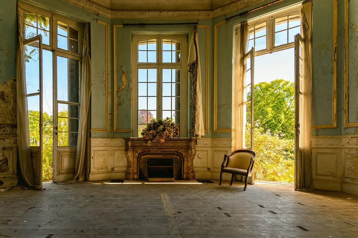 Morning light through shuttered windows in the restored parlour
